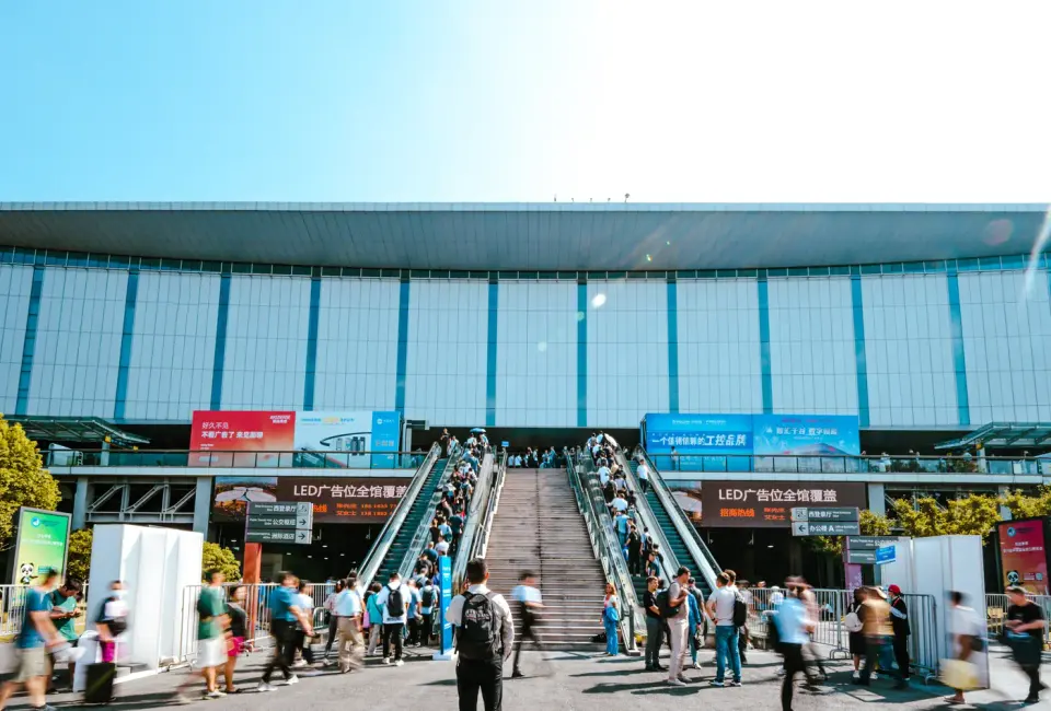 Visitors approaching an exhibition building by stairs and escalators