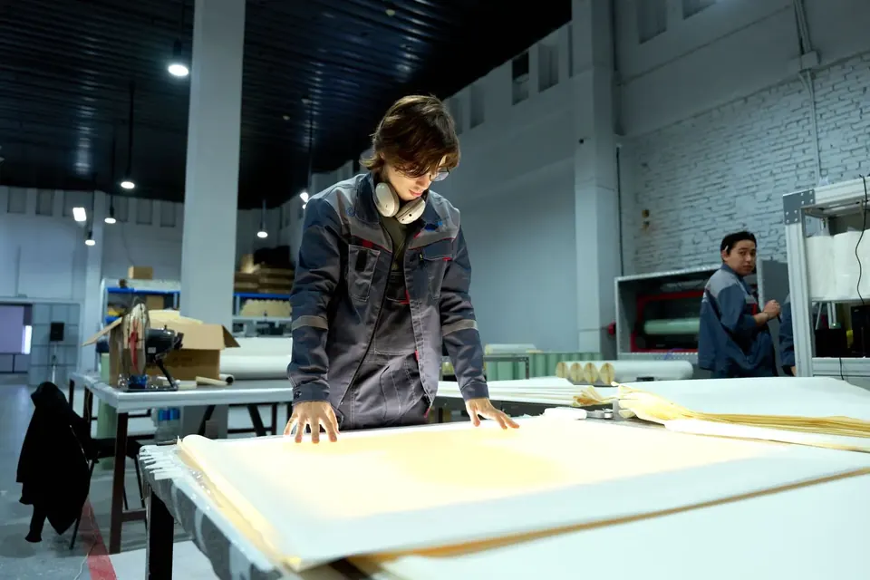 Worker inspecting materials on a factory floor in China