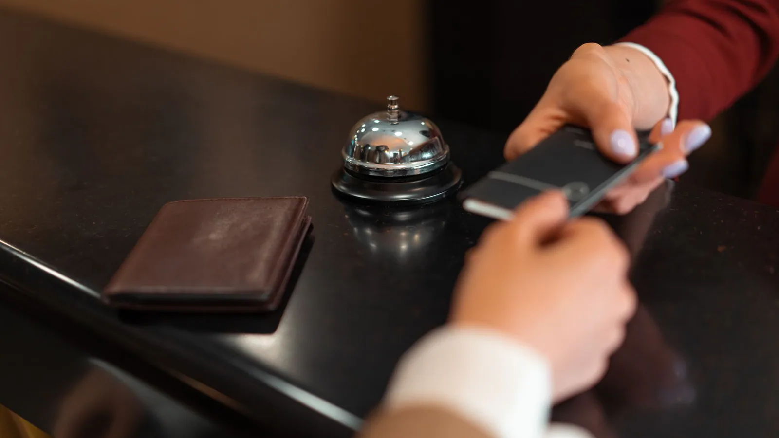 Hotel guests completing check-in paperwork at reception