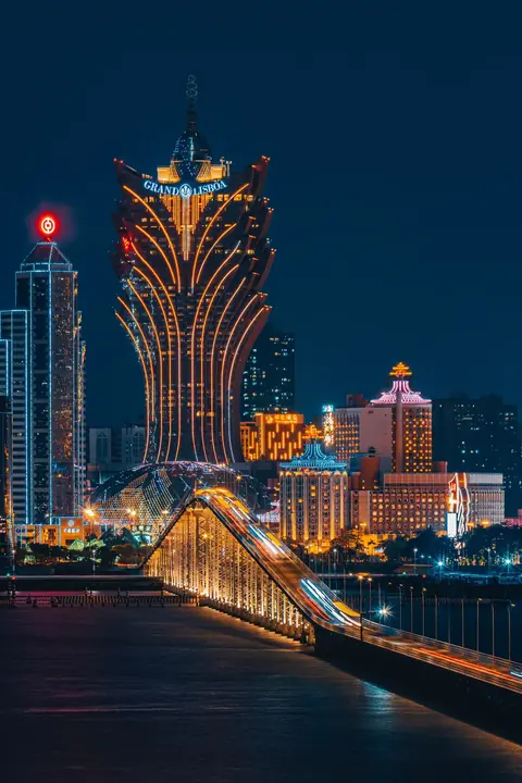 Grand Lisboa casino illuminated in Macau at night
