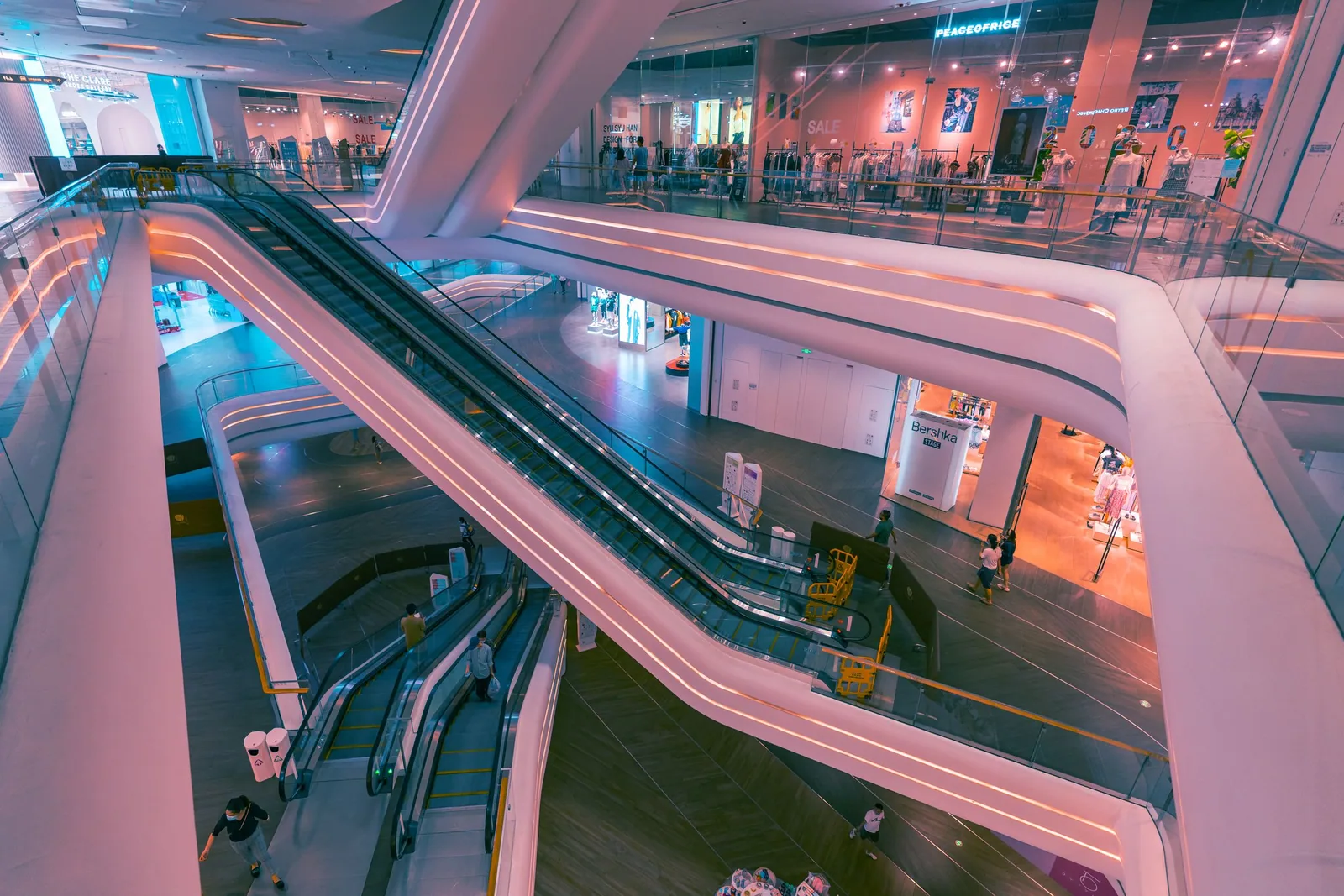 Escalators and retail floors inside a modern Shenzhen shopping centre